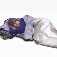 A picture on a white background of a man lying down asleep under a silver survival blanket.